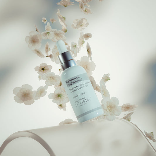 Skincare Serum Bottle with dropper on white camellia flower background