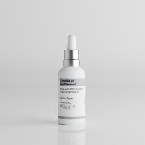 White Bottle with Dropper labelled Camellia Oil by Holistik Skincare on white background