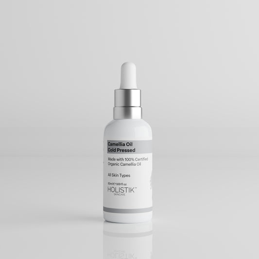 White Bottle with Dropper labelled Camellia Oil by Holistik Skincare on white background