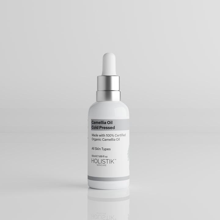 White Bottle with Dropper labelled Camellia Oil by Holistik Skincare on white background