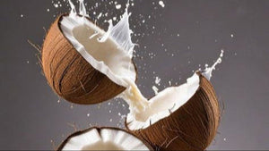 coconut in the air with coconut milk splashing