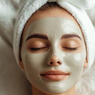 Woman with clay mask on face and towel wrapped around her head