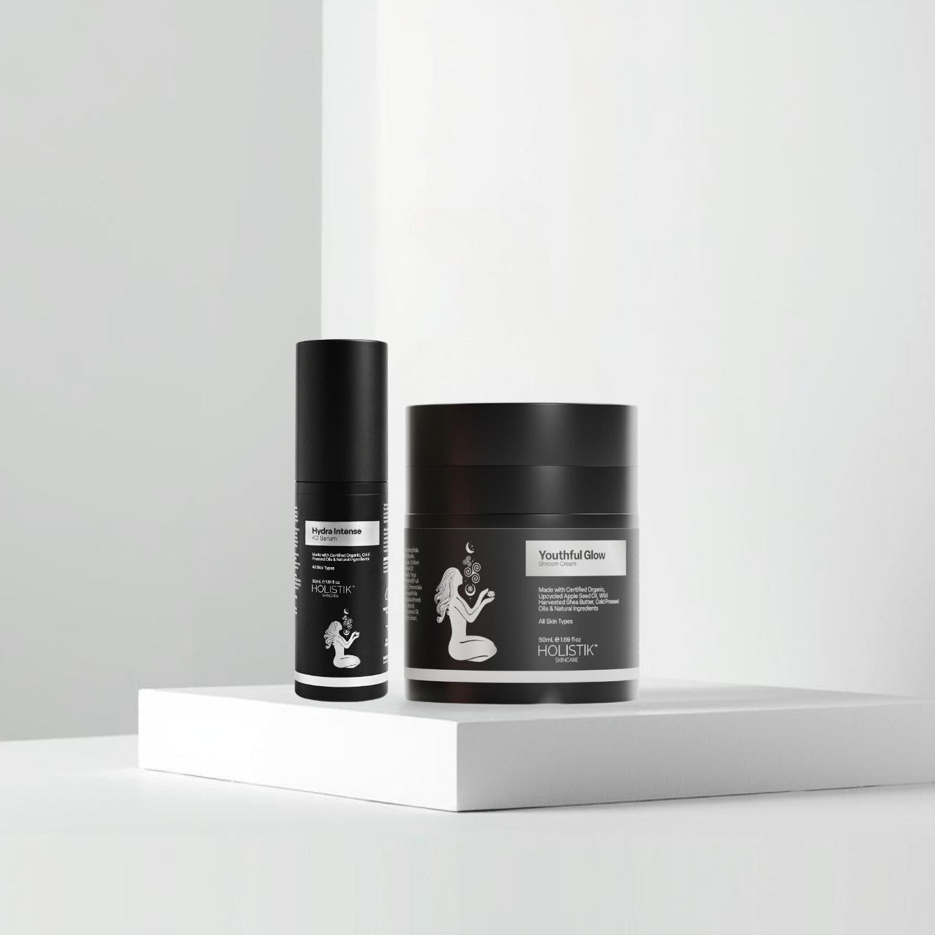 Two black cylindrical containers with labels on a white background