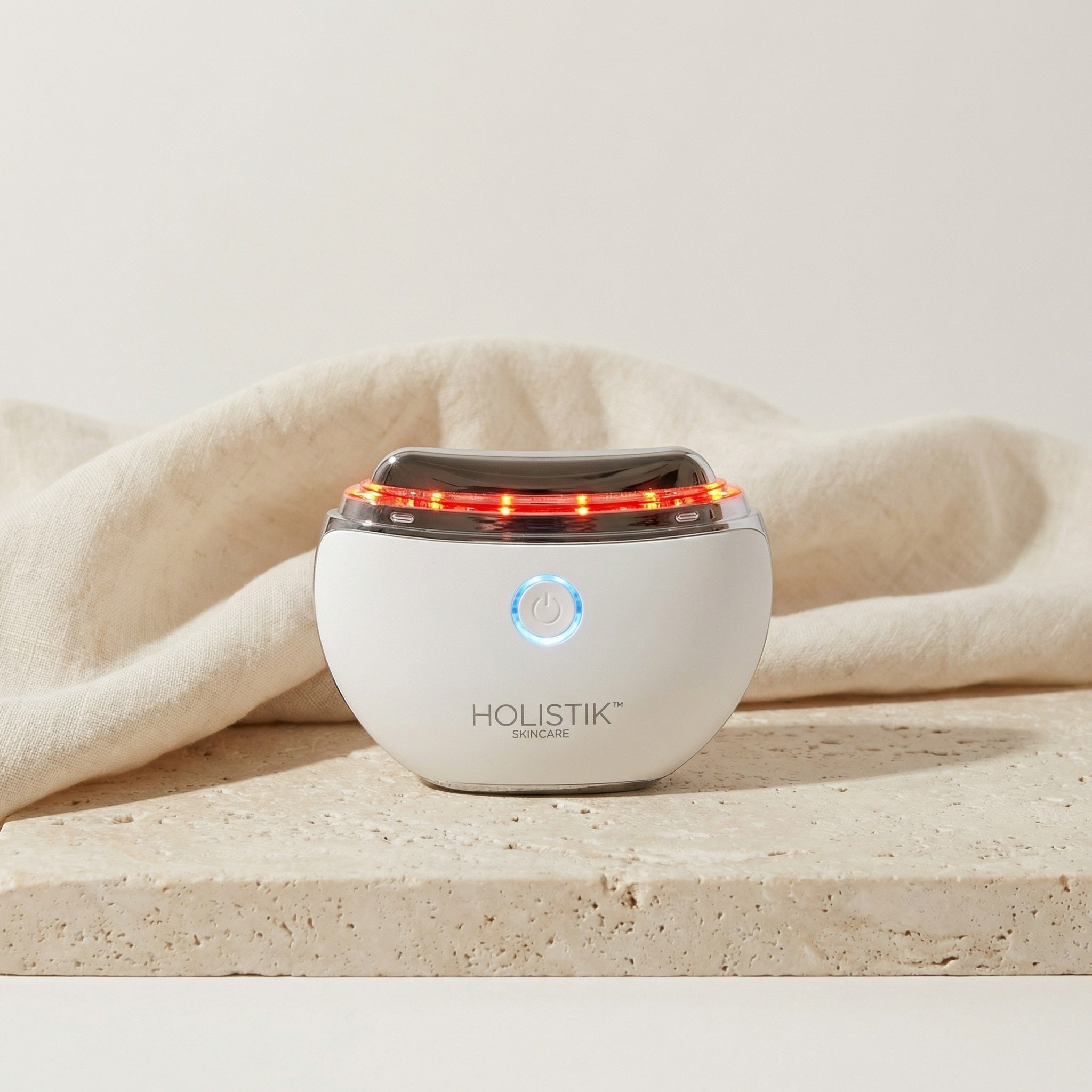 Holistik skincare LED Gua Sha Face device on a neutral background