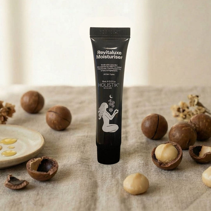 Holistik Skincare Moisturiser tube with macadamia nuts on natural background