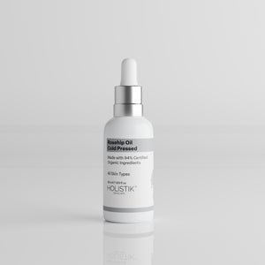 White Skincare Dropper Bottle labelled Rosehip Oil by Holistik Skincare on white background