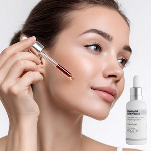 Woman holding a dropper with a skincare product next to a bottle of Holistik Skincare Rosehip Oil